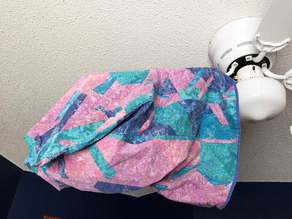 Using a pillowcase to dust fan blades