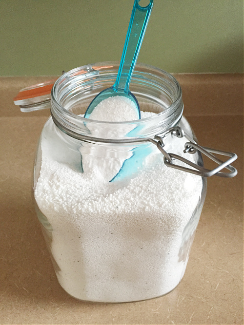 Dishwasher detergent in glass canister with scoop