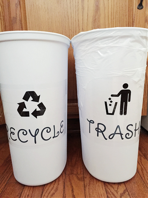Narrow trash cans labeled as trash and recyle