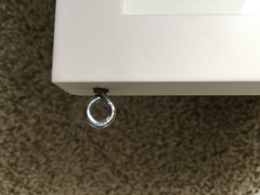 Screw eye screwed into top of picture frame