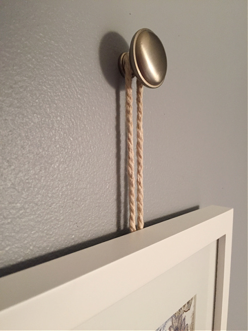 Frame hung from knob using rope