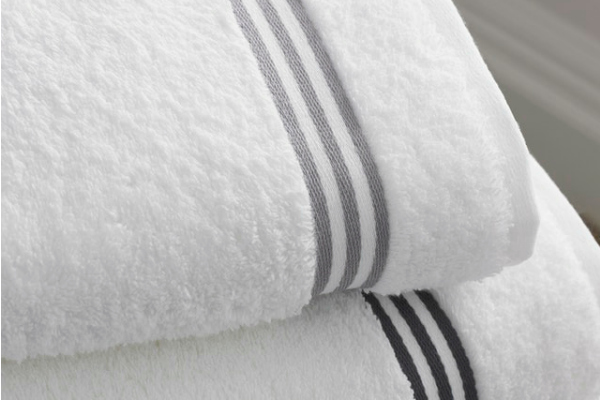 Freshen the Laundry naturally with vinegar and baking soda. Title image of freshly folded towels