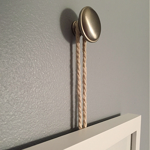Picture Frame hung from a drawer knob with rope