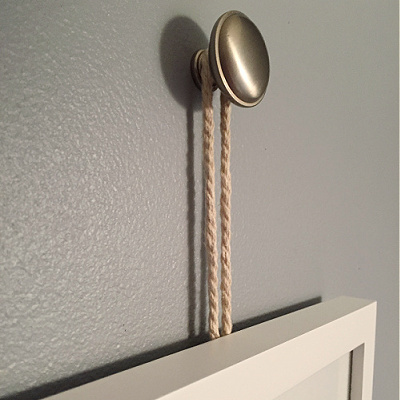 Picture Frame hung from a drawer knob with rope