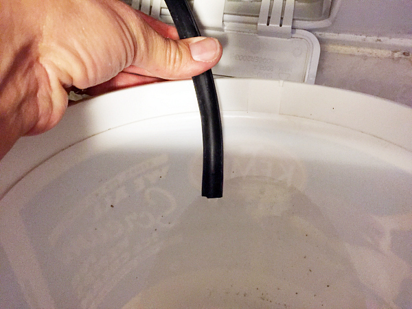 Drain Hose emptying dirty water when Cleaning A Washing Machine