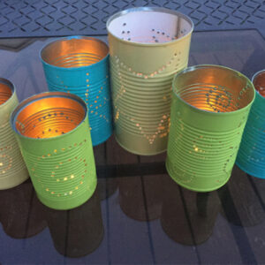 DIY Tin Can Lanterns on table at dusk