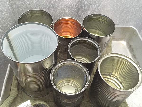 Tin cans filled with water in deep freeze