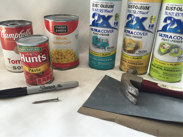 Items needed to make DIY Tin Can Lanterns: Cans, marker, spray paint, hammer and nail.