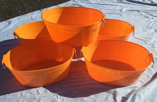 Bright orange bins from the dollar store that will be get a makeover and be used for pantry organization