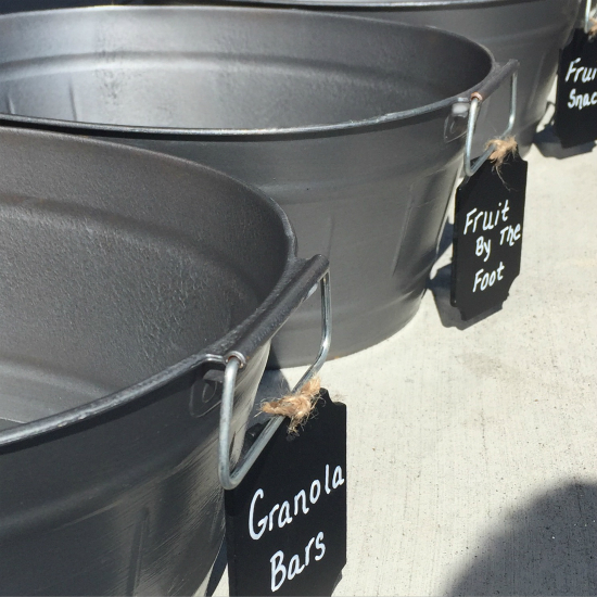 Dollar store bins spray painted in metal spray paint with attached chalkboard labels