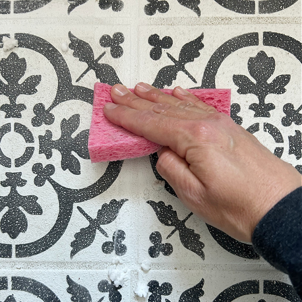 Wiping Grout with wet sponge