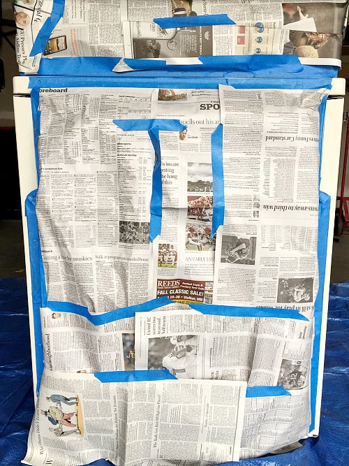 Appliance covered in newspaper to cover areas that should not be painted
