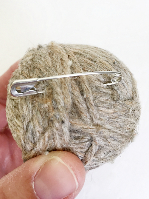 Safety pin clipped to dryer ball