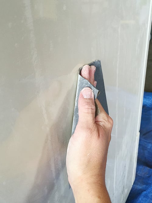 Sanding appliance with fine grit sandpaper prior to painting