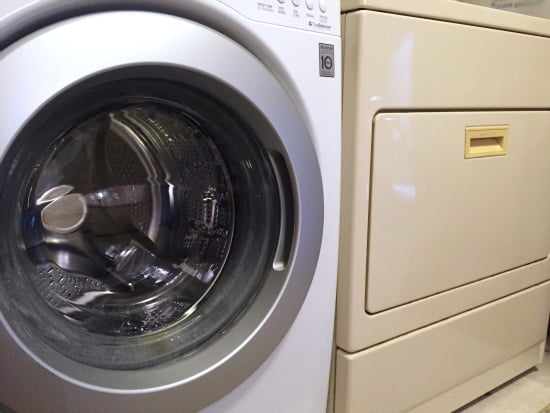 White washing machine beside almon dryer prior to painting