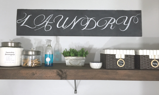 Chalkboard sign made from cardboard hung in the laundry room