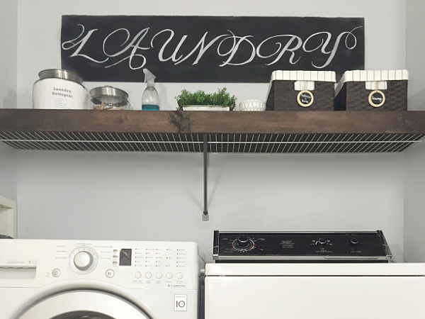 DIY Wood overlay placed on top of wire shelf in laundry room