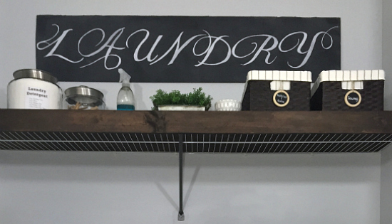 Underside of wire shelf showing how the DIY Wood Overlay sits on top of the existing wire shelf to create the look of a chucky wood shelf in the laundry room