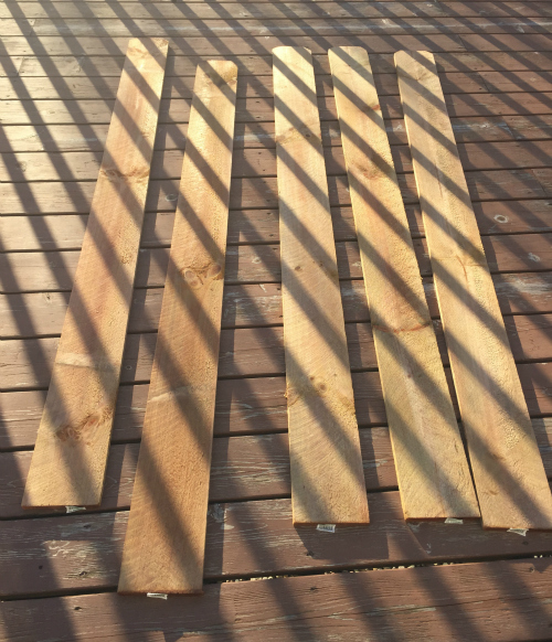 Cedar fence posts lying on deck outside to dry