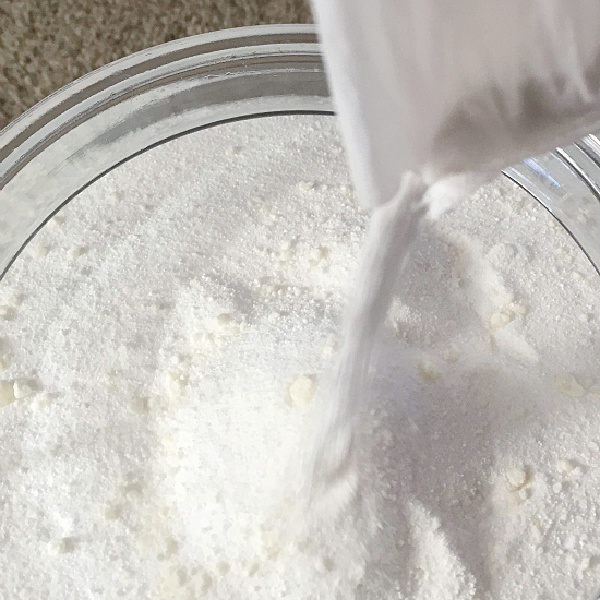Pouring Homemade Laundry Detergent into Storage Container