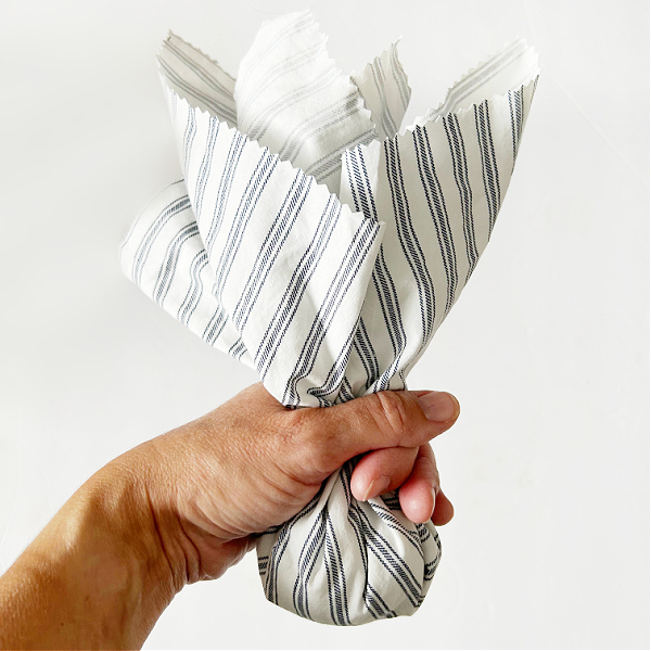 Cinching fabric around lavender sachet mixture