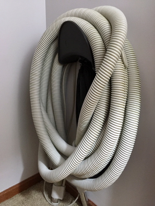 Vacuum hose on wall mount