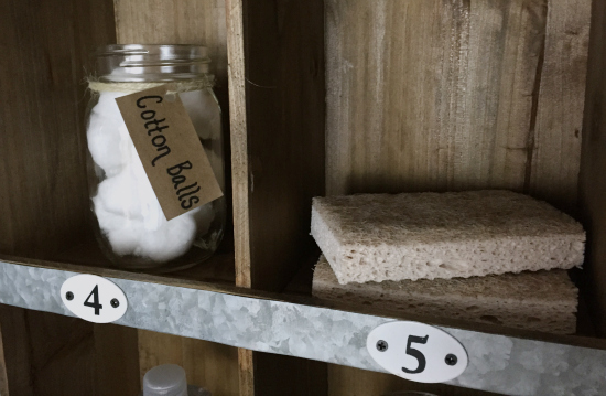 Sponges and cotton balls in cubby storage unit