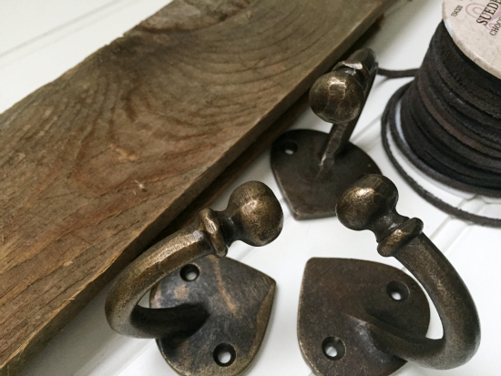 Barn wood, hooks, and suede cord to be made into mop and broom holder