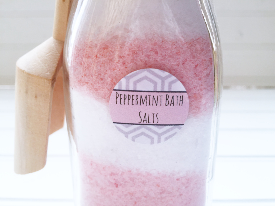 DIY Peppermint Bath Salts layered in pink and white placed in a glass milk jar and labeled