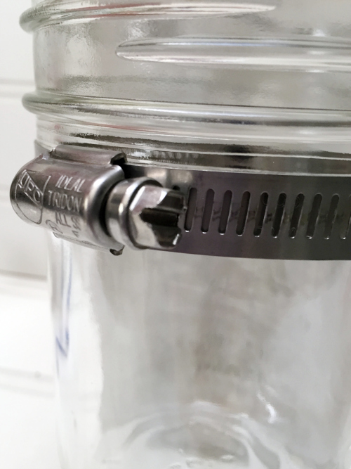 Adding mason jars to DIY Mason Jar Toothbrush Holder