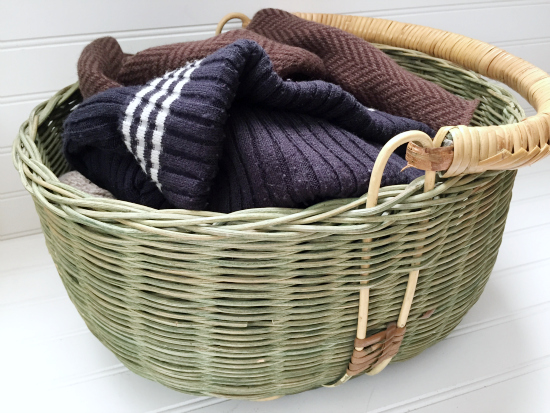 Green wicker basket holding winter items