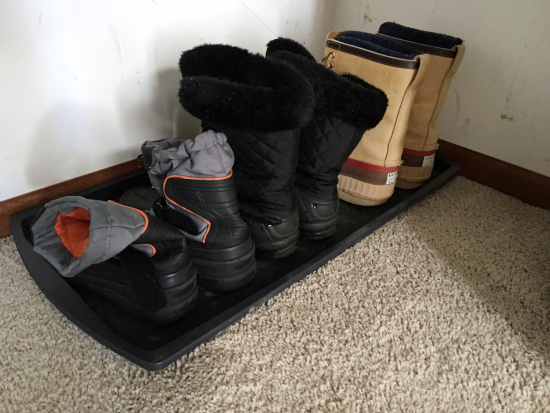 Winter boots on plastic boot tray in closet