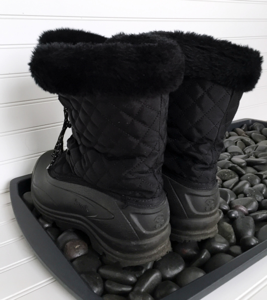 Boots sitting on DIY Boot Tray made with a tray and river rocks