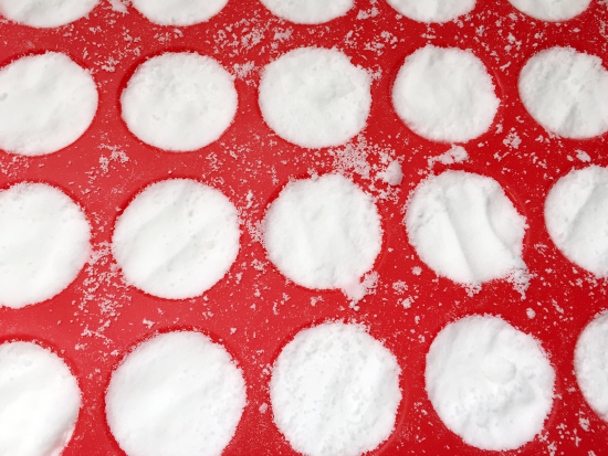 DIY Toilet Bomb mixture pressed into a mini muffin silicone mold