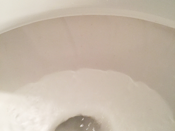 Clean white toilet bowl after removing brown toilet stains