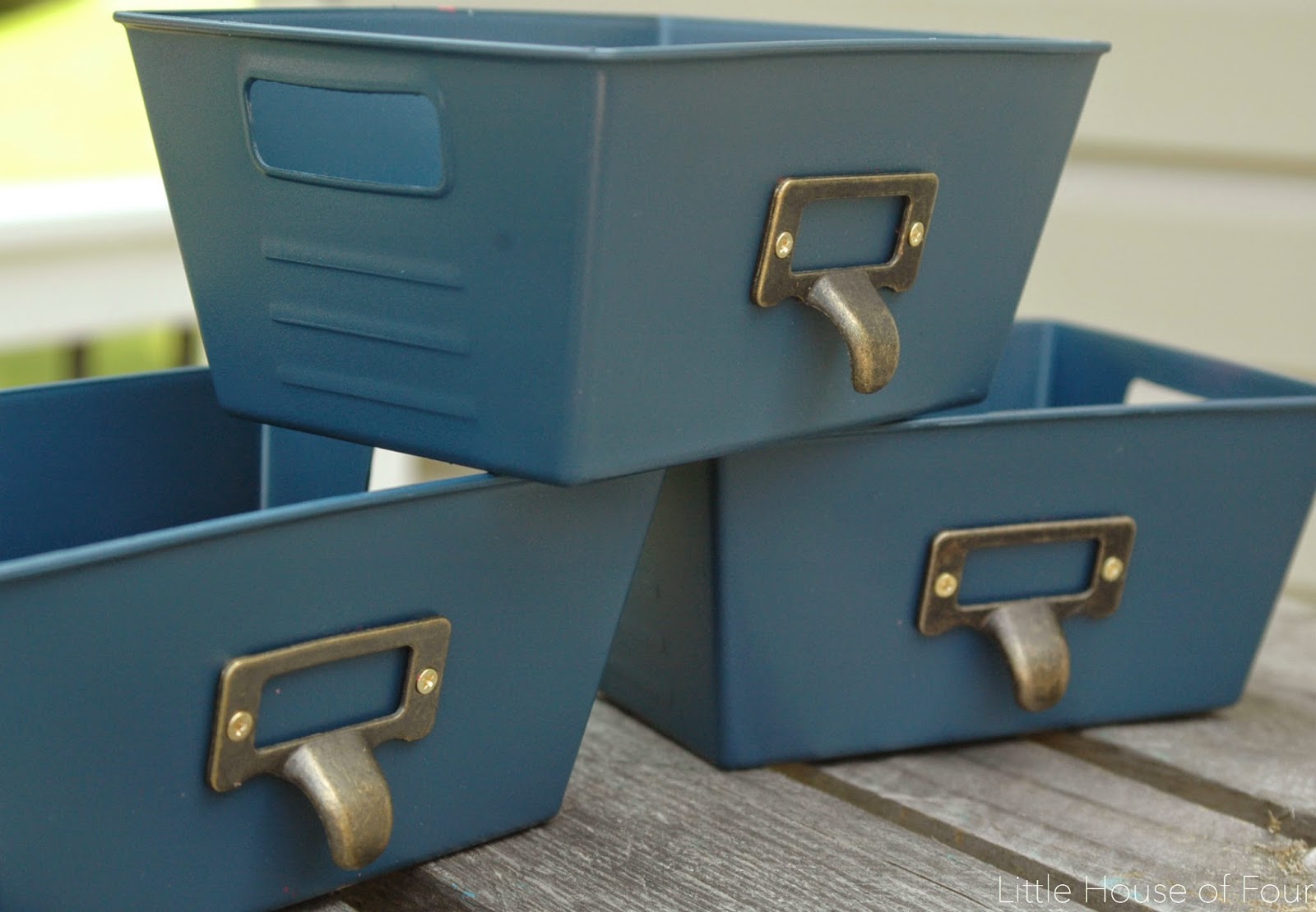 Small dollar store bins after makeover with navy paint and small vintage pulls