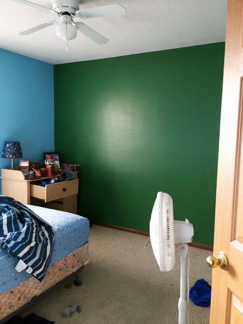 Boy's bedroom with green wall prior to football themed makeover