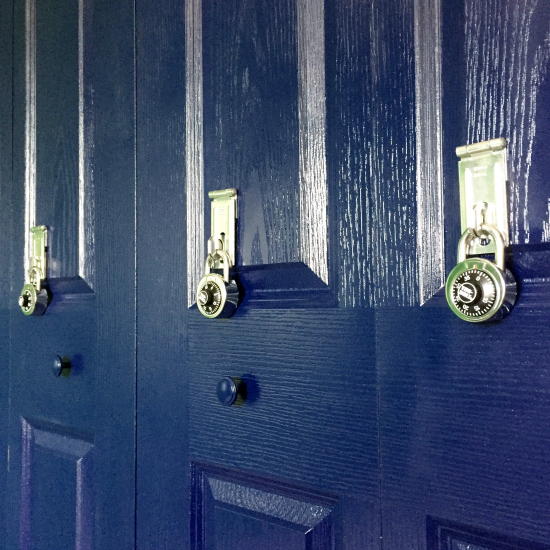 Bifold closet door turned into a faux locker bay with padlocks