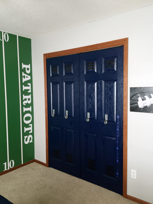 Boy's football themed bedroom displaying bifold closet doors made over to look like a locker bay