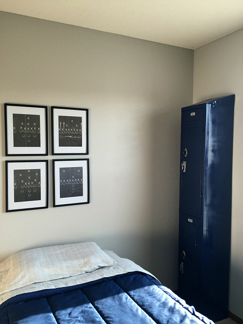 A vintage locker is turned into a dresser for boy's football themed bedroom