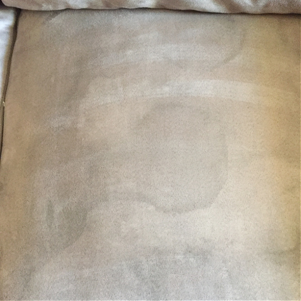 Water stains shown after using rubbing alcohol to clean a microfiber couch