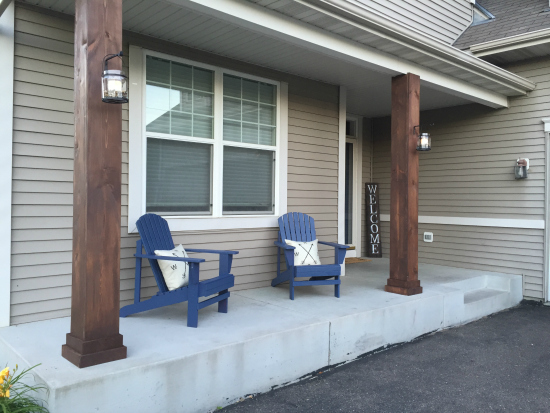 Dark stained poles on porch after makeover