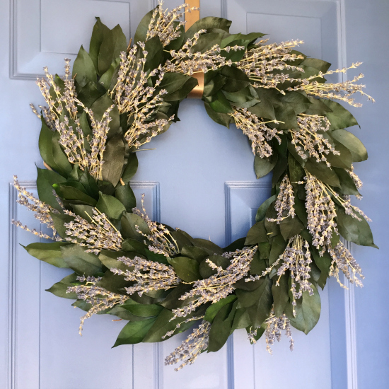 Wreath made with greenery and dried lavender hanging from front door