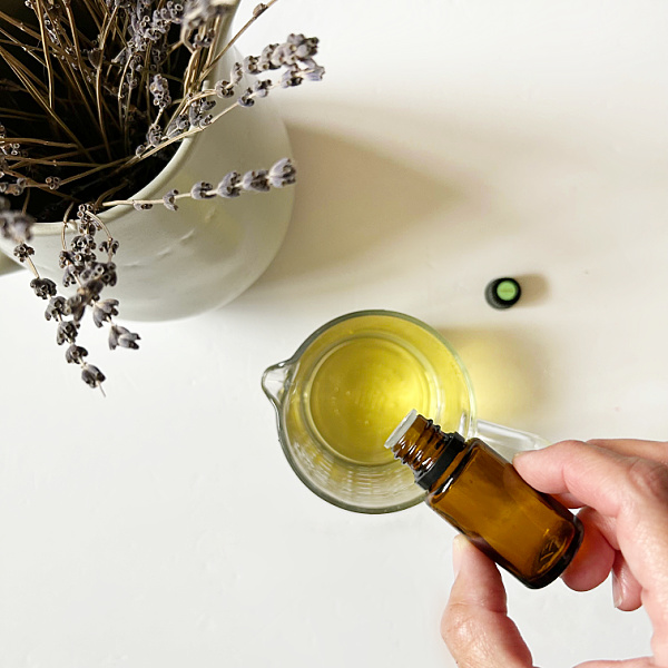 Adding essential oil to melted wax to make wax melts