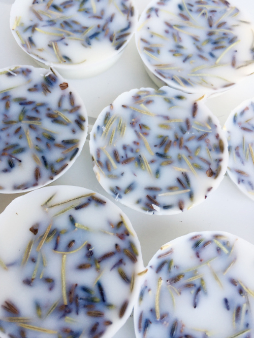 Homemade wax melts using essential oils with dried lavender buds and rosemary