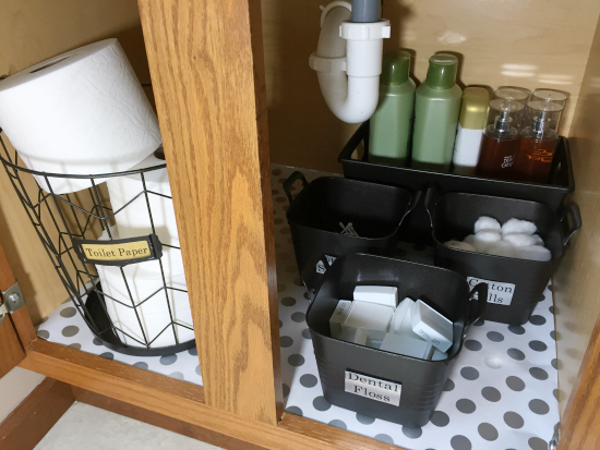 Under bathroom sink organization using dollar store bins