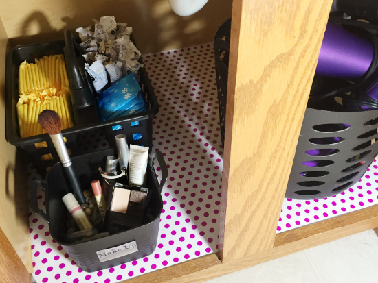 Under bathroom sink organization using dollar store bins