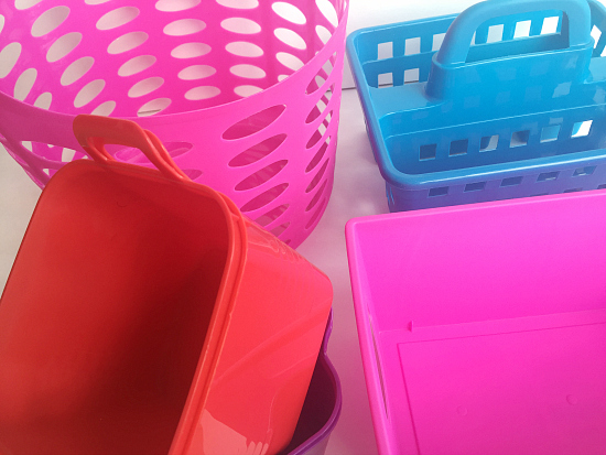 Colorful bins from the dollar store that will be used for Organizing Under the Bathroom Sink