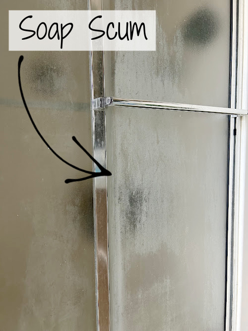 Soap scum on glass shower doors before cleaning