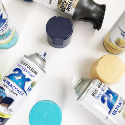 Bottles of spray paint with lids off